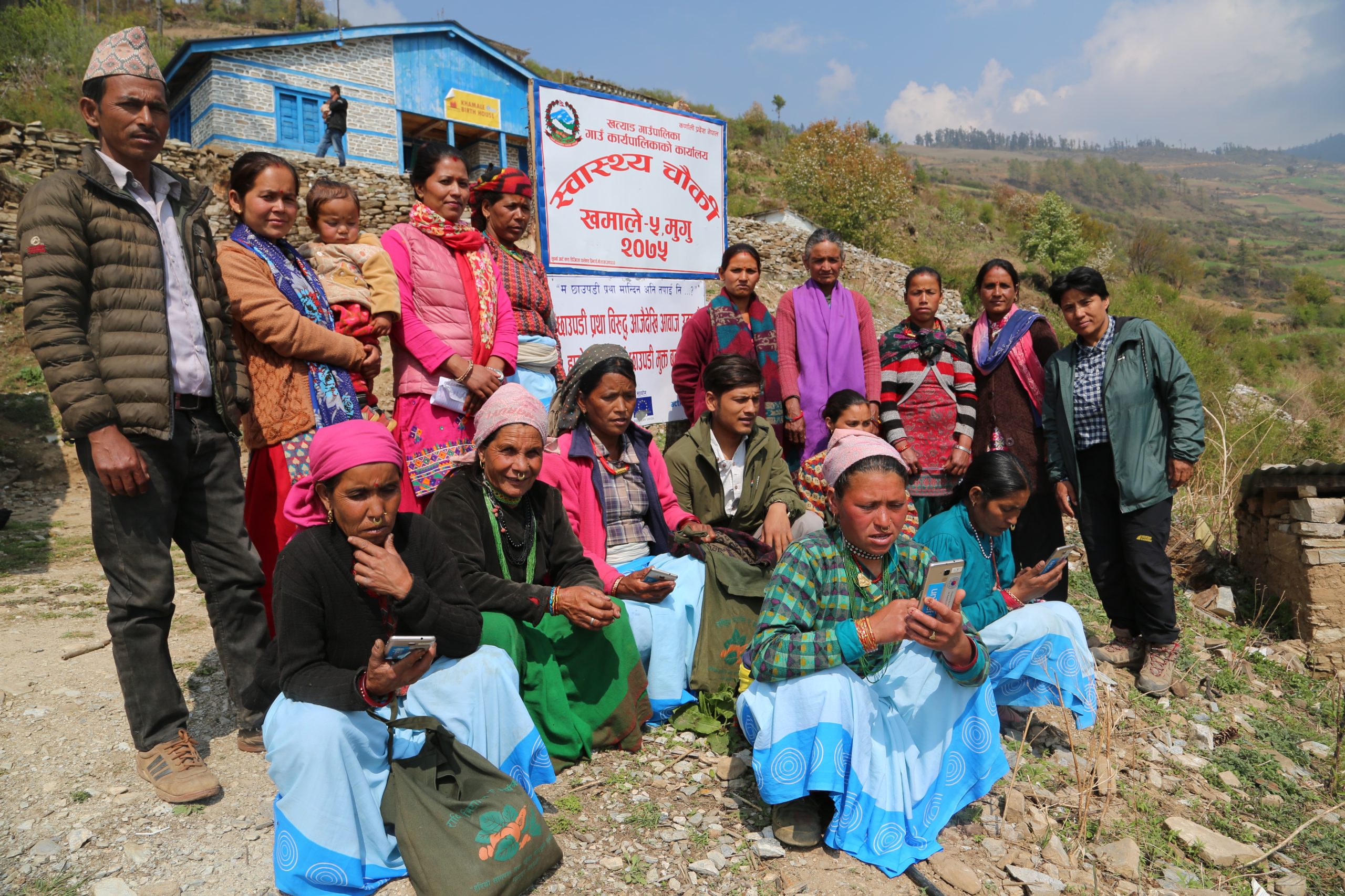 Female Community Health Volunteers in Mugu, Nepal, using mobile phones together as part of Amakomaya's field work